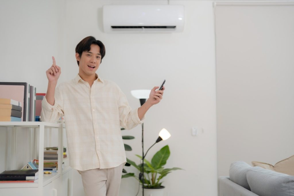 a man is satisfied with the air conditioner