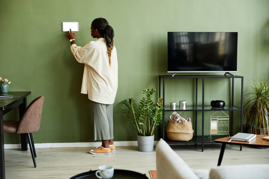 a woman operate smart heating device