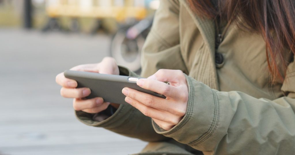 Woman play video game on cellphone